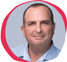 professional man smiling, light blue background with red circular accent