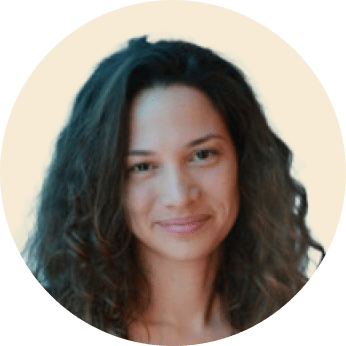 curly-haired woman smiling, light background portrait of a woman with natural beauty