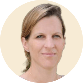 portrait of a woman with light brown hair and a neutral expression against a pale background, female professional headshot