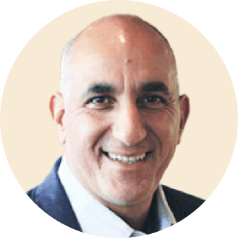 smiling man in a round frame wearing a suit against a light background, professional portrait with a welcoming expression