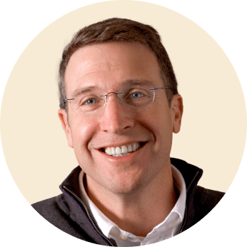 happy man with glasses smiling, portrait of a man in a round frame wearing a dark jacket